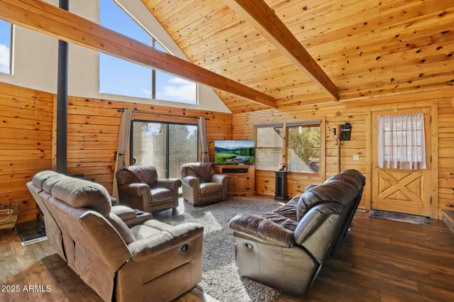 a living room with furniture a wooden floor and next to a window