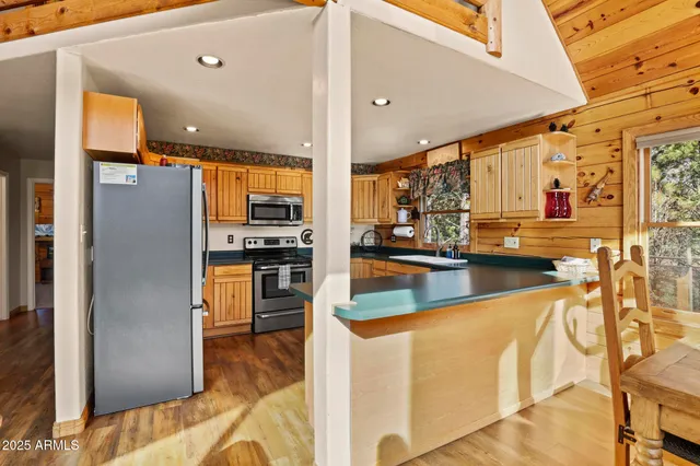 a kitchen with stainless steel appliances a refrigerator and a stove