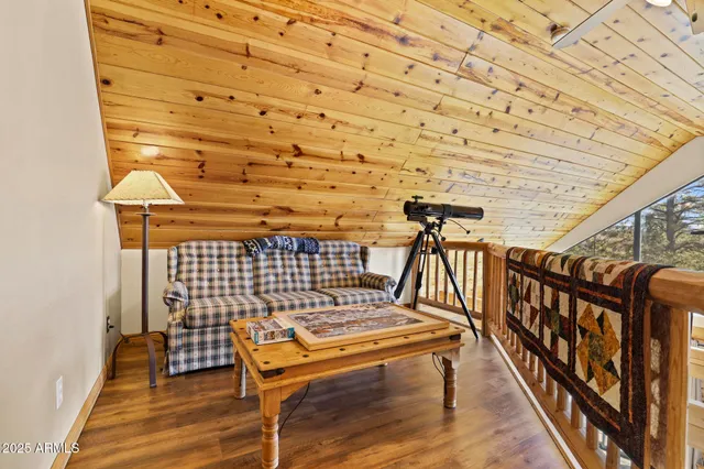 a bedroom with a bed couch and a larger window