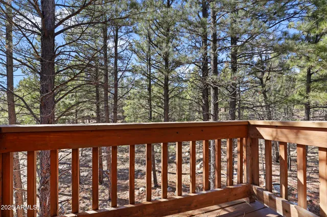 a living room with pool table furniture and windows
