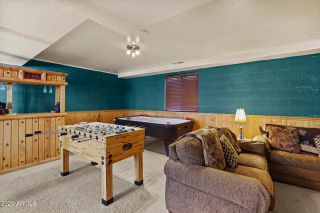 a room with pool table and windows