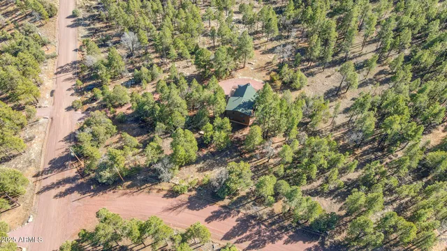 an aerial view of house with yard and mountain in the background