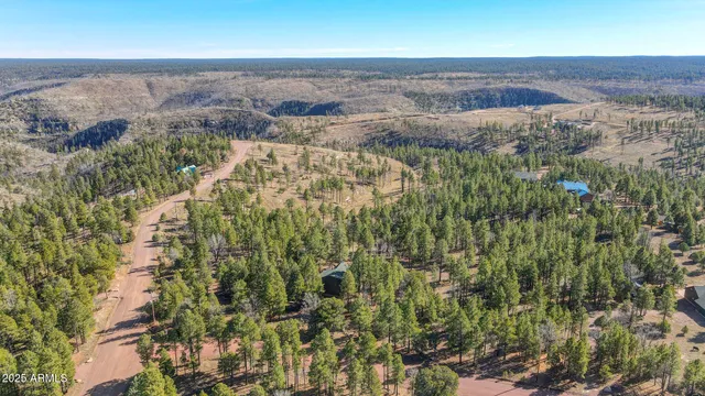 a roof deck with table and chairs under an umbrella