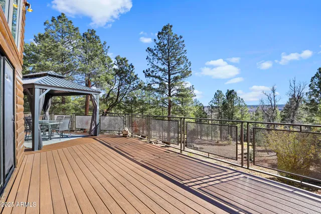 a view of a balcony with wooden floor and outdoor space