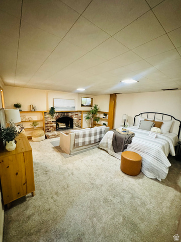 4245 3320 East Holladay, UT 84124 - Photo 33 of 51 Spacious room featuring light-toned carpeting, a brick fireplace with a wood mantle, built-in wooden shelving, and recessed ceiling lighting
