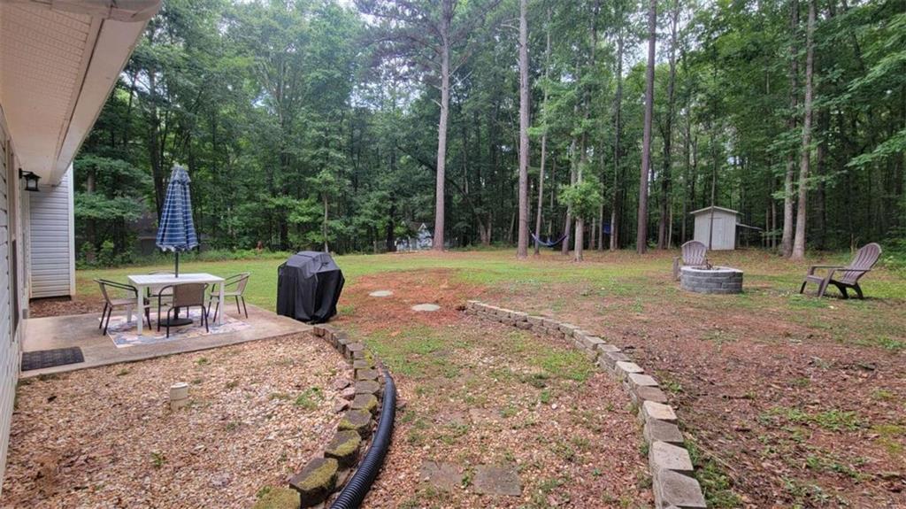 2140 Summerset Drive Monroe, GA 30656 - Photo 31 of 43 a view of a backyard with chairs and a slide