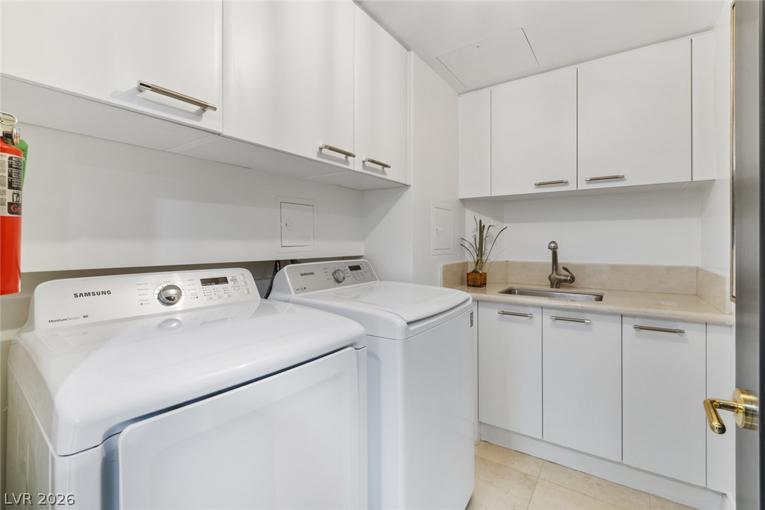 2857 Paradise Road, Unit 602 Las Vegas, NV 89109 - Photo 32 of 33 Ample built-in cabinetry and a functional utility sink maximize efficiency in this dedicated laundry space.