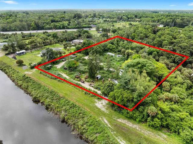 an aerial view of residential houses with outdoor space and swimming pool
