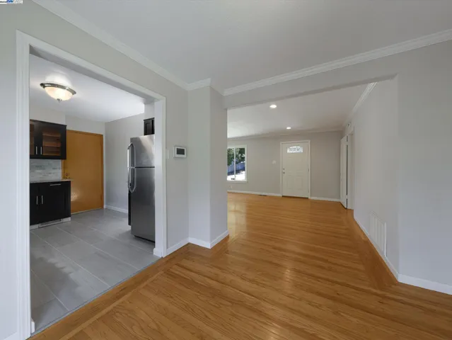a view of empty room with wooden floor