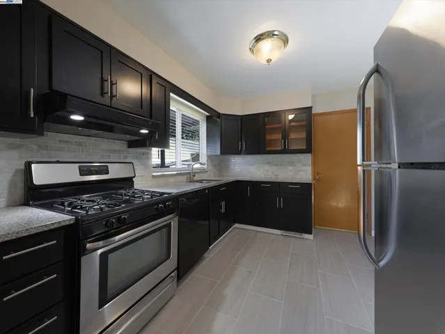 a view of a room with wooden floor and windows