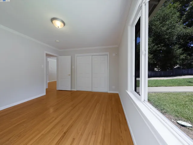 a view of a house with a yard and potted plants