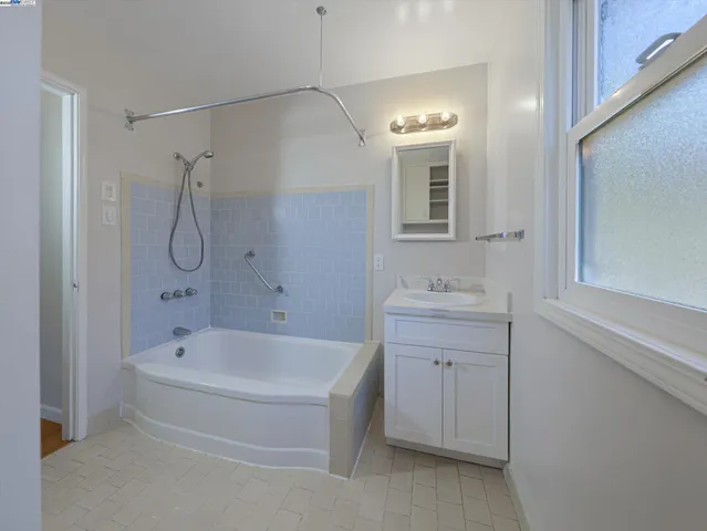 a view of a house with a yard and large tree