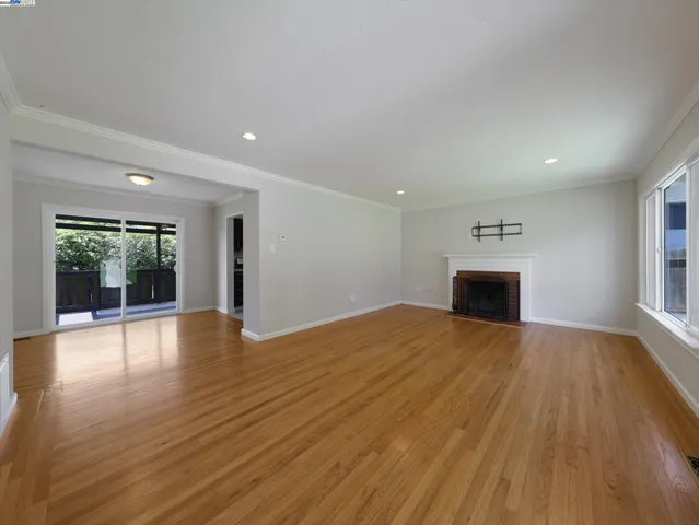 a view of a room with wooden floor and fence