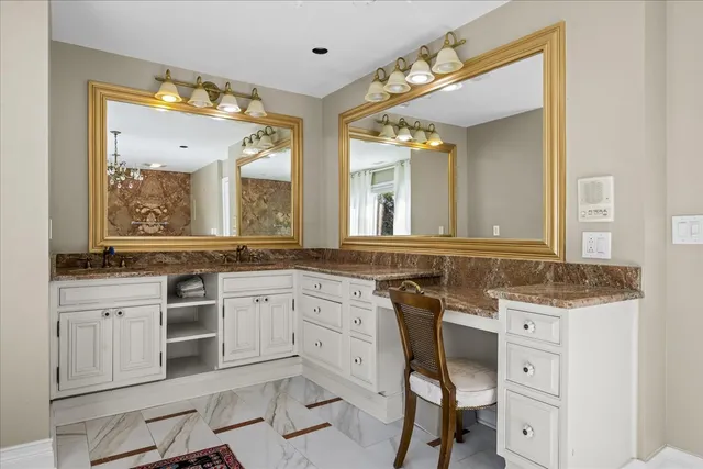 a spacious bathroom with a granite countertop sink mirror and a