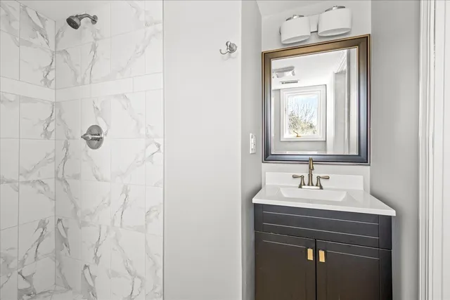 a bathroom with a sink vanity and a mirror