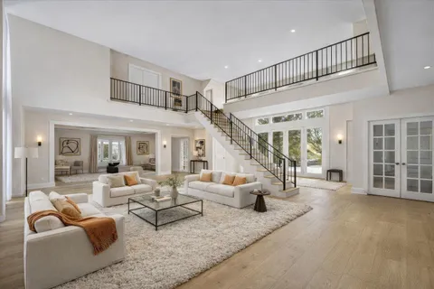 a work room with wooden floor and a chandelier