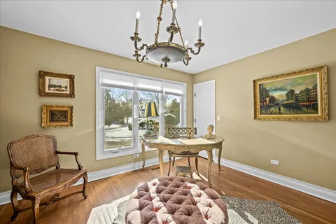 a kitchen with stainless steel appliances granite countertop a kitchen island hardwood floor and a view of living room
