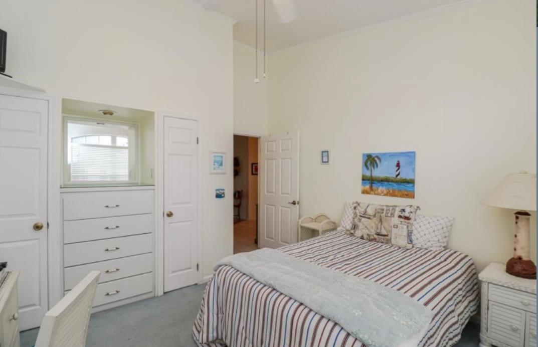 307 Augusta Circle St. Augustine, FL 32086 - Photo 11 of 31 a bedroom with a bed and a dresser