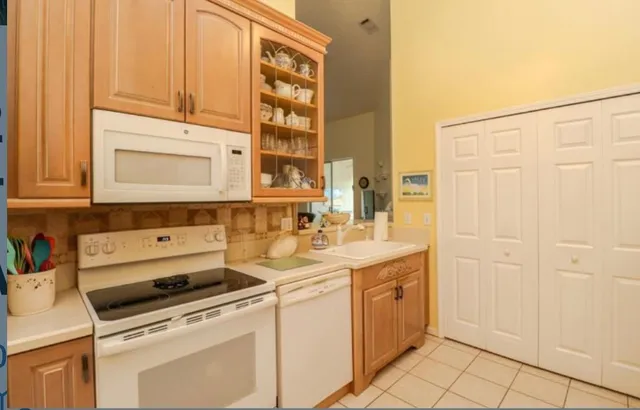 a utility room with cabinets washer and dryer