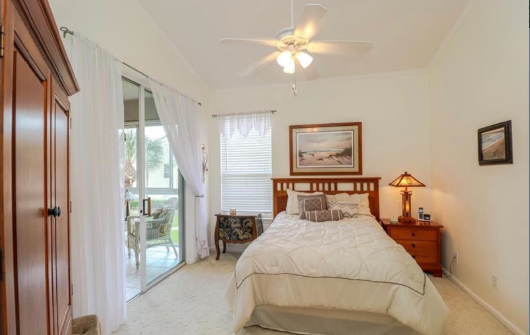 307 Augusta Circle St. Augustine, FL 32086 - Photo 18 of 31 a bedroom with a large bed and a chandelier