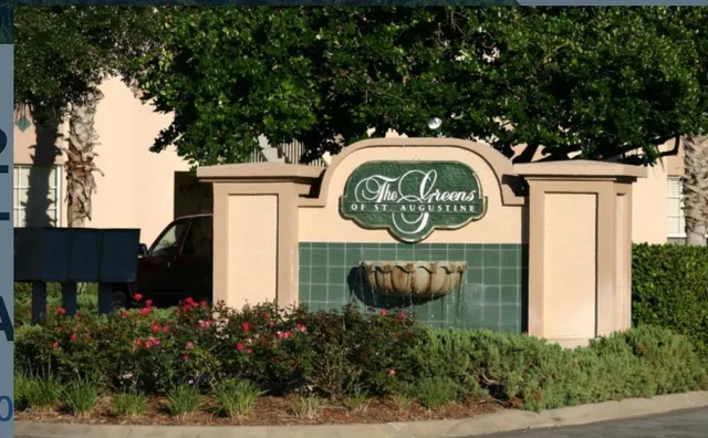 a sign that is on a brick wall