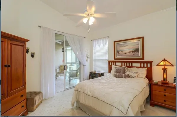 a bedroom with a large bed and a chandelier