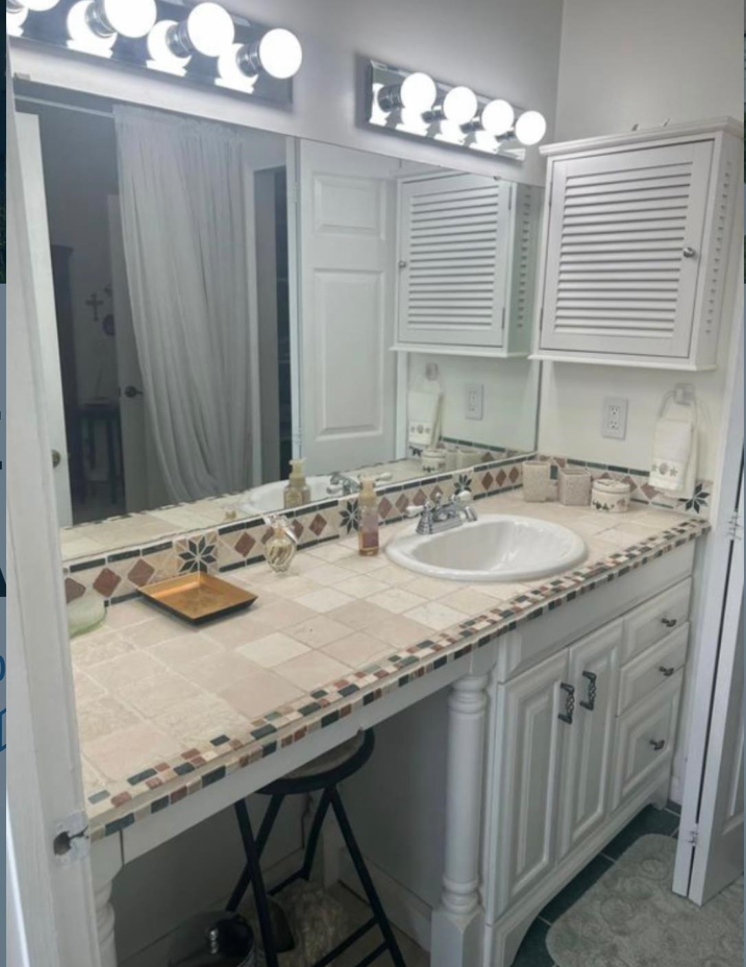 307 Augusta Circle St. Augustine, FL 32086 - Photo 22 of 31 a bathroom with a granite countertop sink and a mirror