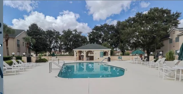 a swimming pool with outdoor seating and yard