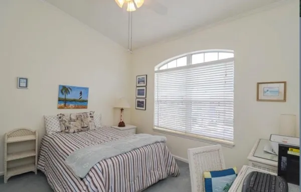a bedroom with a bed and a table chair