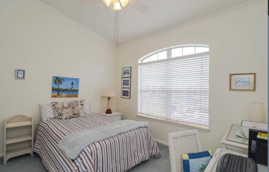 307 Augusta Circle St. Augustine, FL 32086 - Photo 25 of 31 a bedroom with a bed and a table chair
