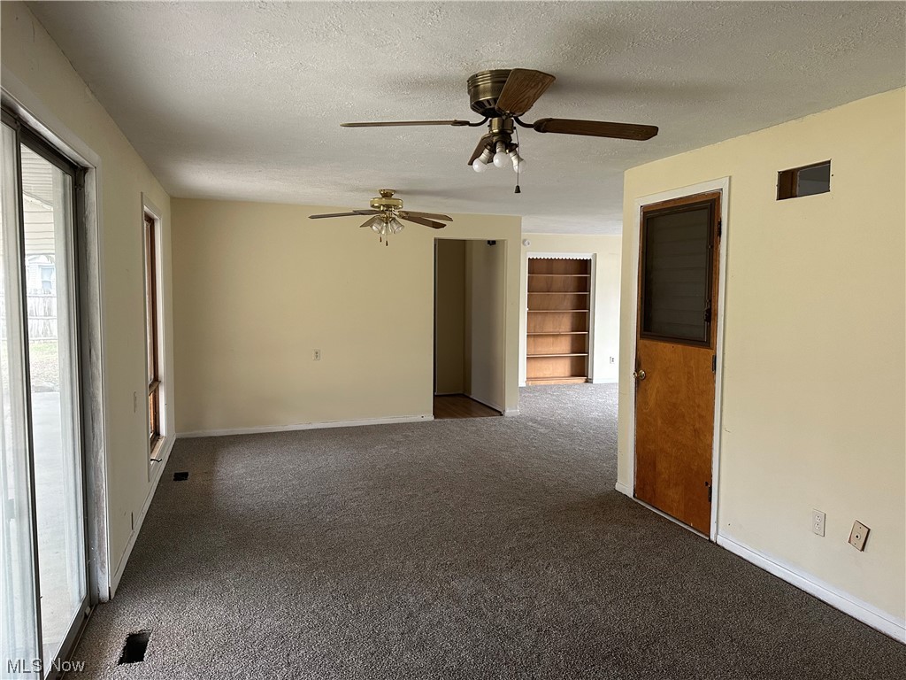 4410 Lane Road Painesville, OH 44077 - Photo 6 of 30 Carpeted spare room featuring ceiling fan and a textured ceiling