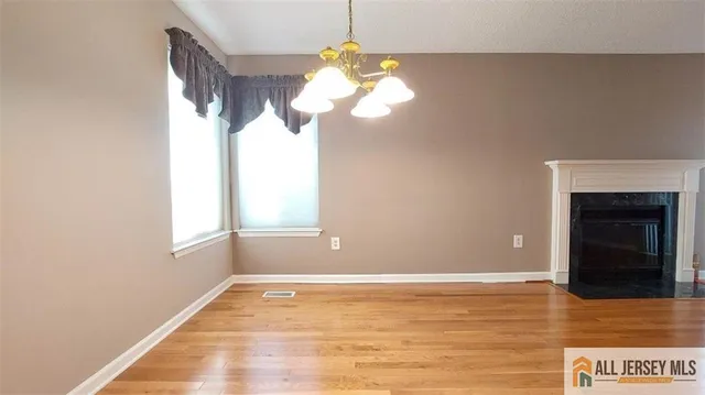a view of a chandelier fan and a window