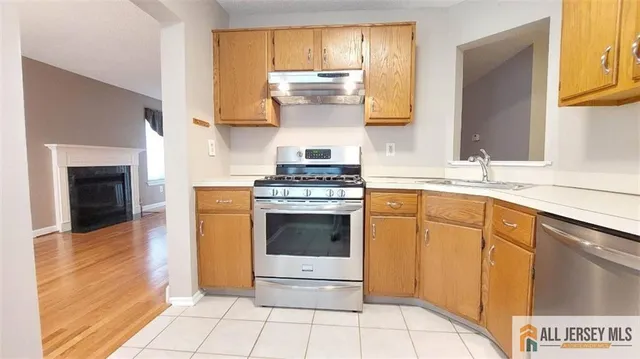 a kitchen with a stove top oven sink and cabinets
