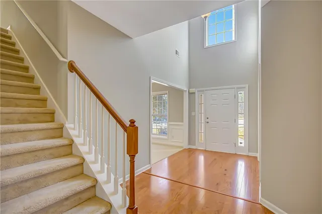 a living room with furniture kitchen view and a window