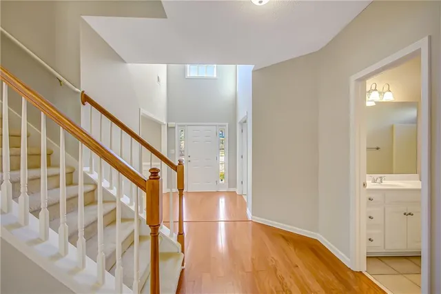 a view of an empty room and kitchen with sink
