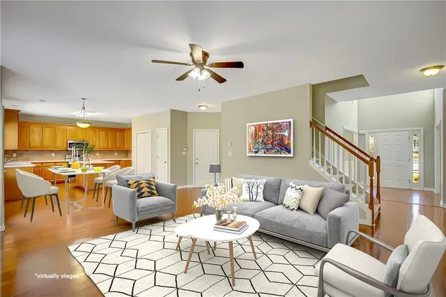 a kitchen with granite countertop cabinets stainless steel appliances a sink and wooden floor