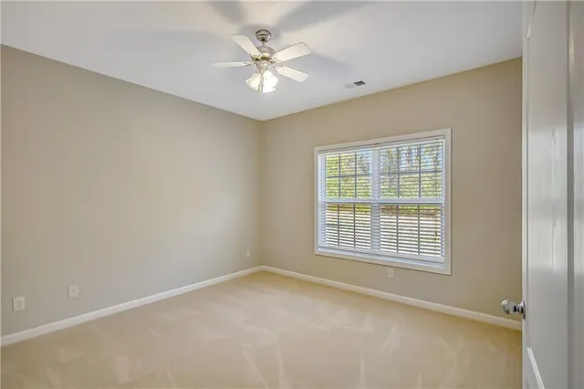 a spacious bathroom with a granite countertop sink a large mirror a bathtub and a window