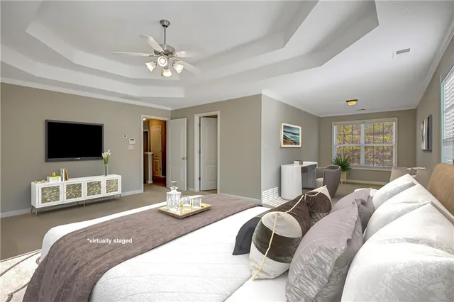 a view of a livingroom with a ceiling fan and window