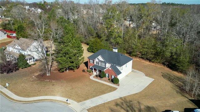 an aerial view of a house with yard