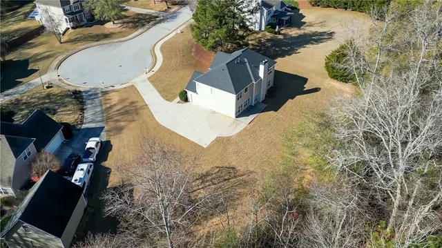 a view of a house with a yard and a fountain
