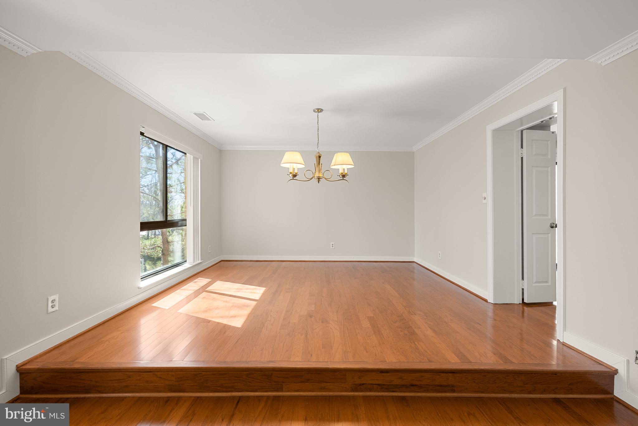 11400 Strand Drive, Unit R310 Rockville, MD 20852 - Photo 11 of 35 wooden floor in an empty room with a window