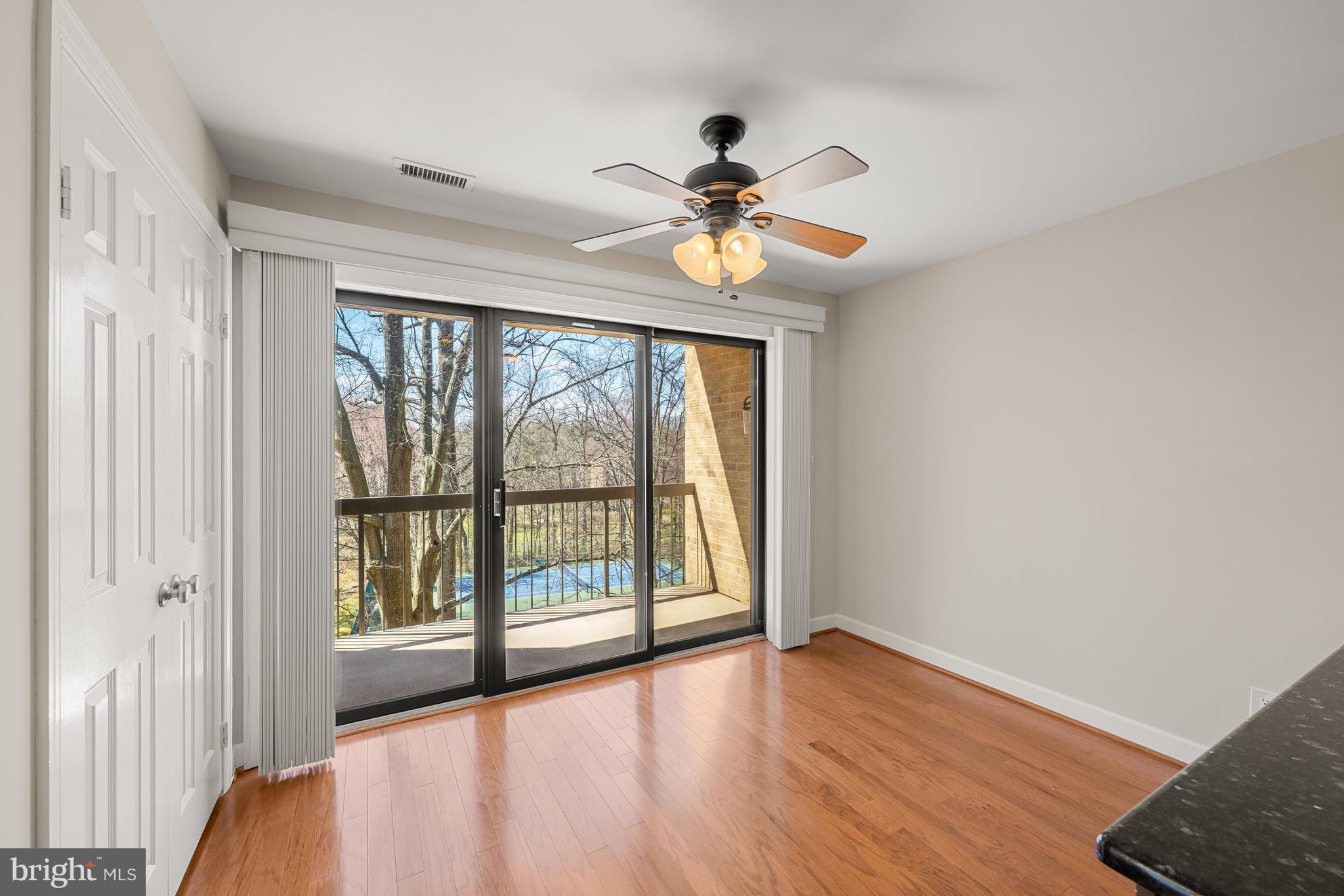 11400 Strand Drive, Unit R310 Rockville, MD 20852 - Photo 16 of 35 wooden floor in an empty room with a window