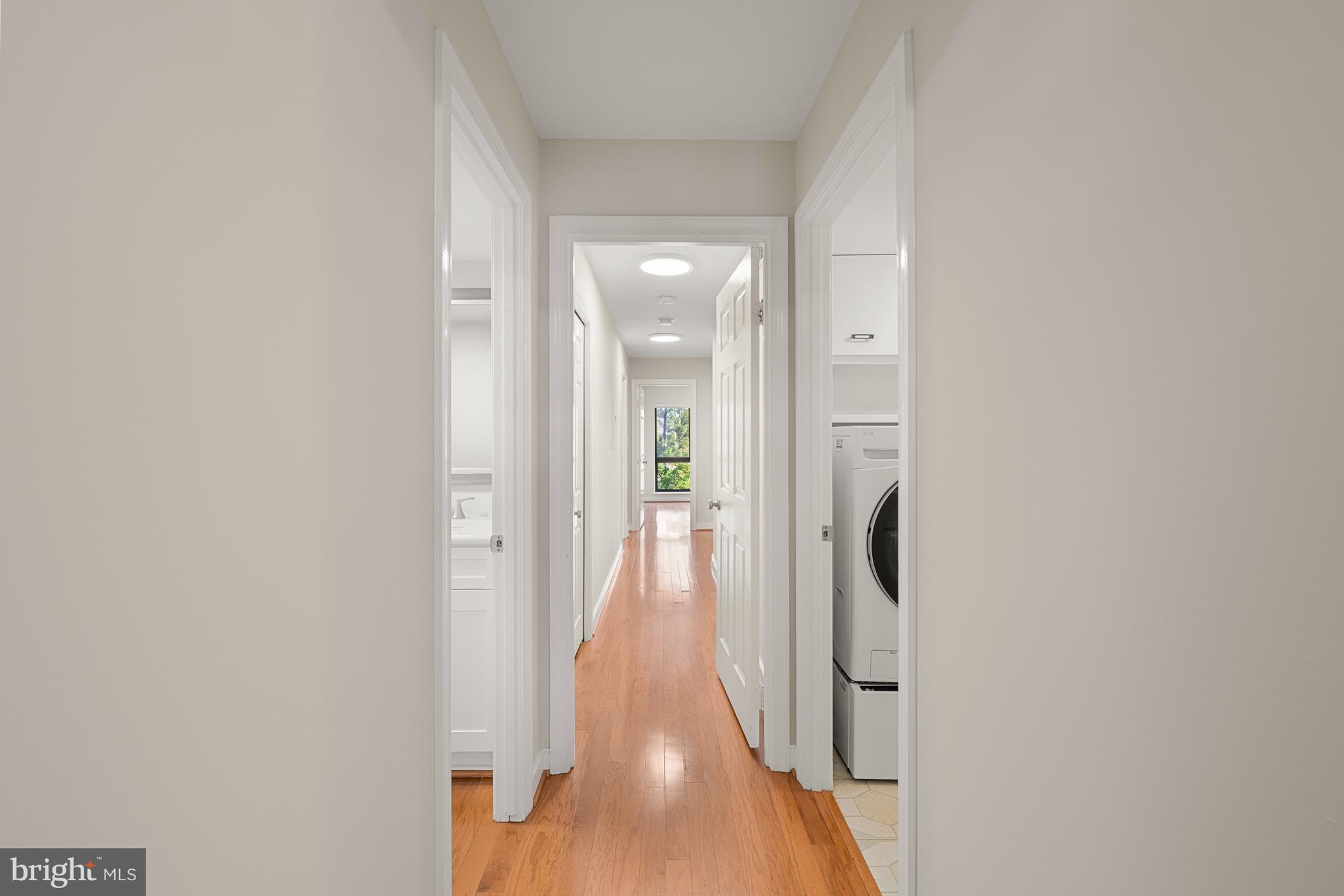 11400 Strand Drive, Unit R310 Rockville, MD 20852 - Photo 18 of 35 a view of a hallway with wooden floor and staircase