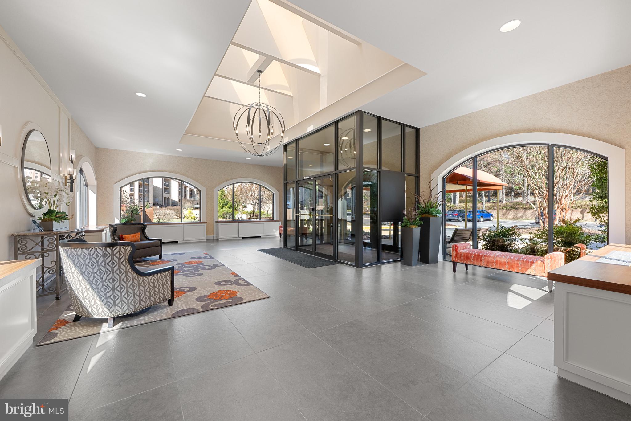11400 Strand Drive, Unit R310 Rockville, MD 20852 - Photo 2 of 35 a living room with furniture a rug and a floor to ceiling window