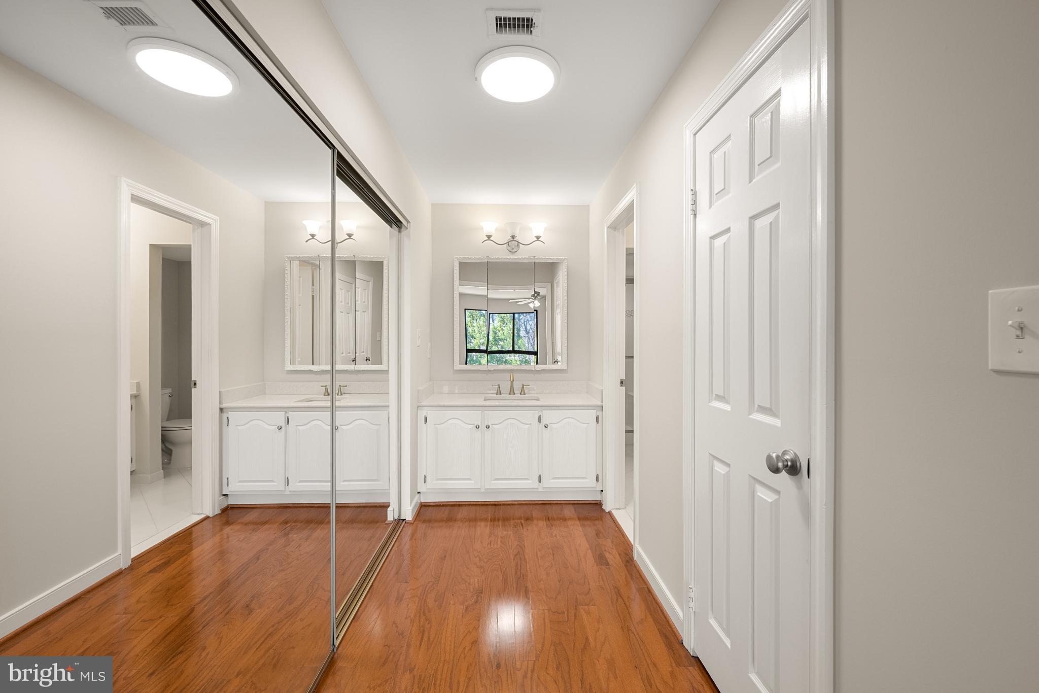 11400 Strand Drive, Unit R310 Rockville, MD 20852 - Photo 22 of 35 a view of a hallway with wooden floor and staircase