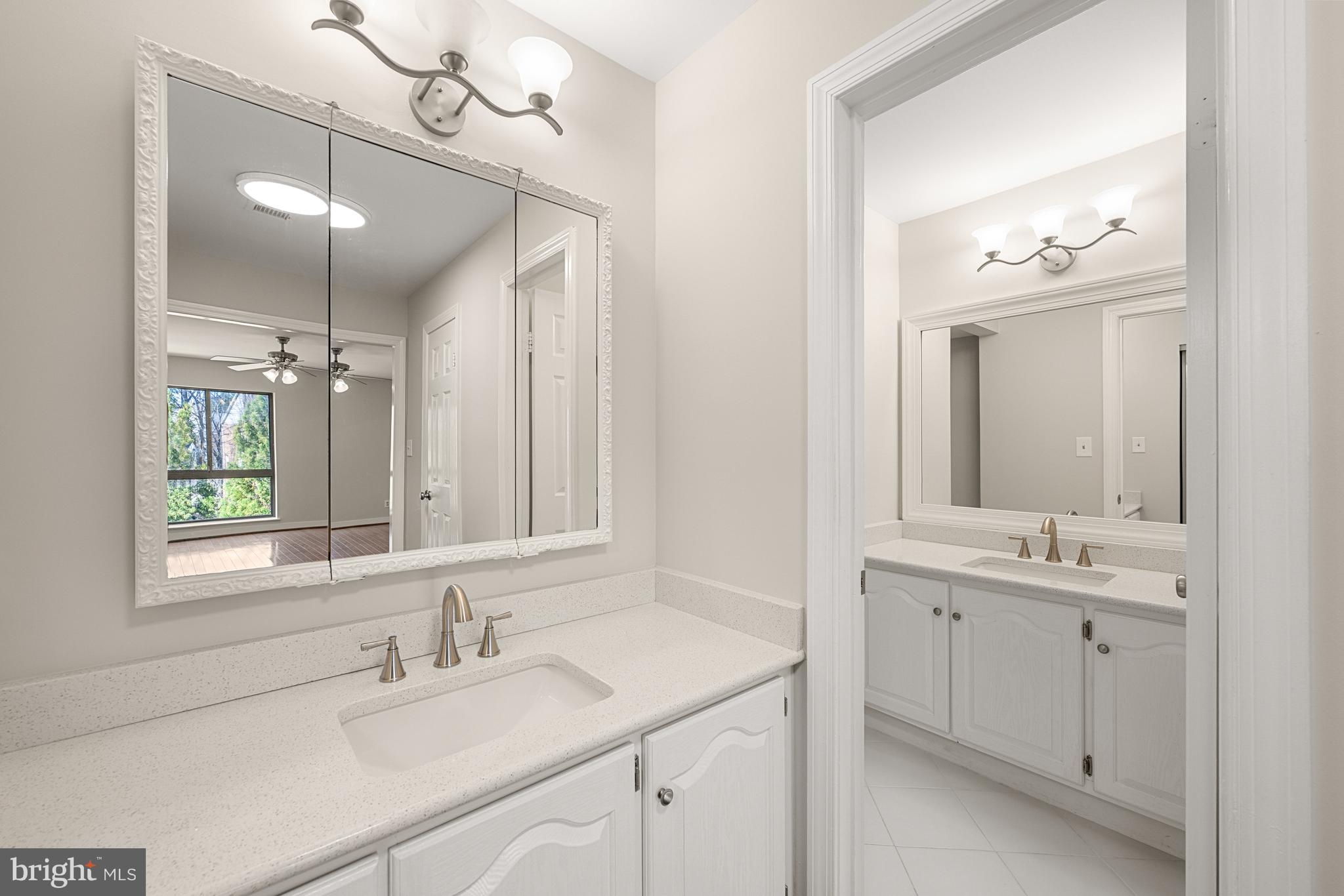 11400 Strand Drive, Unit R310 Rockville, MD 20852 - Photo 23 of 35 a bathroom with a sink double vanity and a mirror