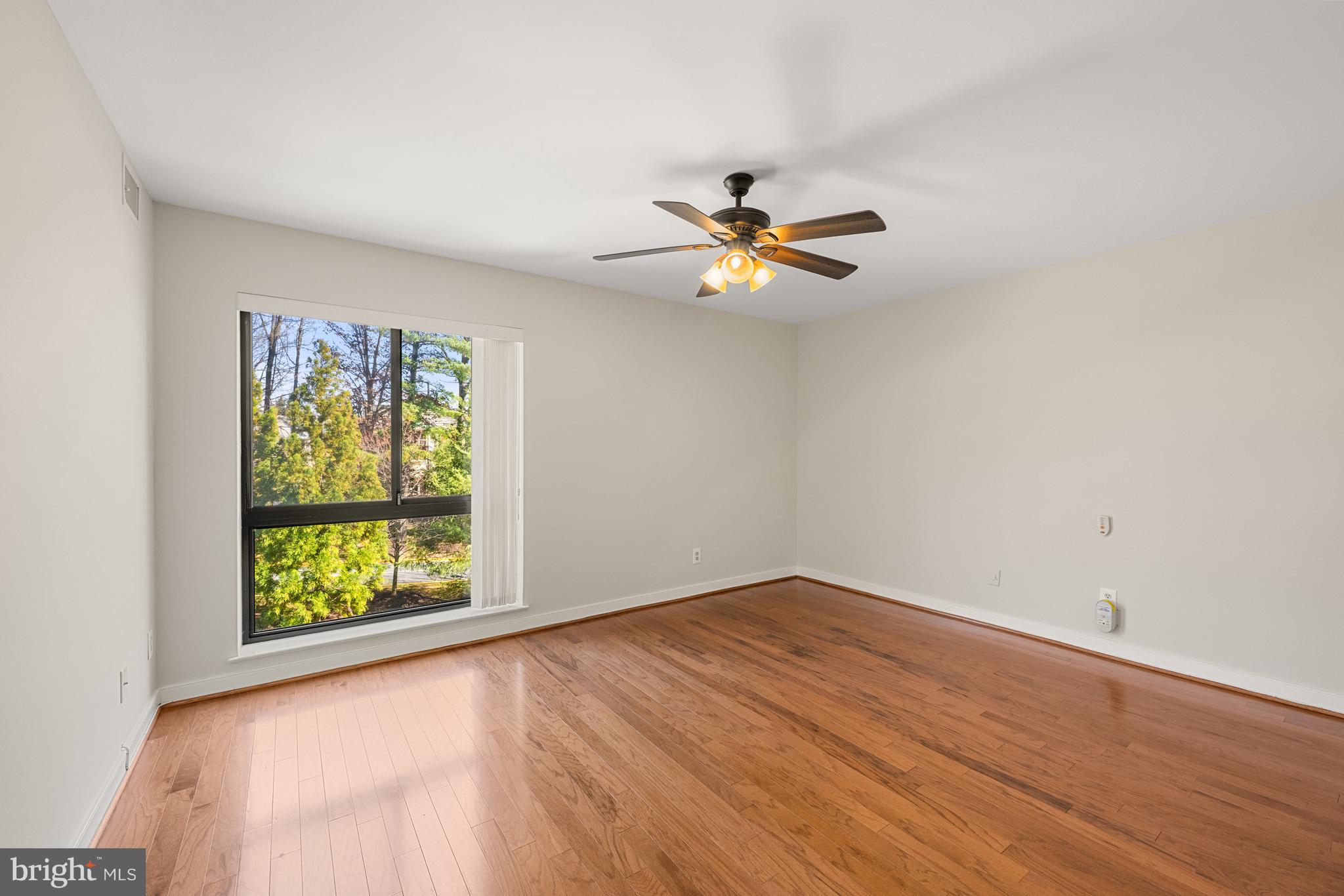 11400 Strand Drive, Unit R310 Rockville, MD 20852 - Photo 26 of 35 an empty room with windows and ceiling fan