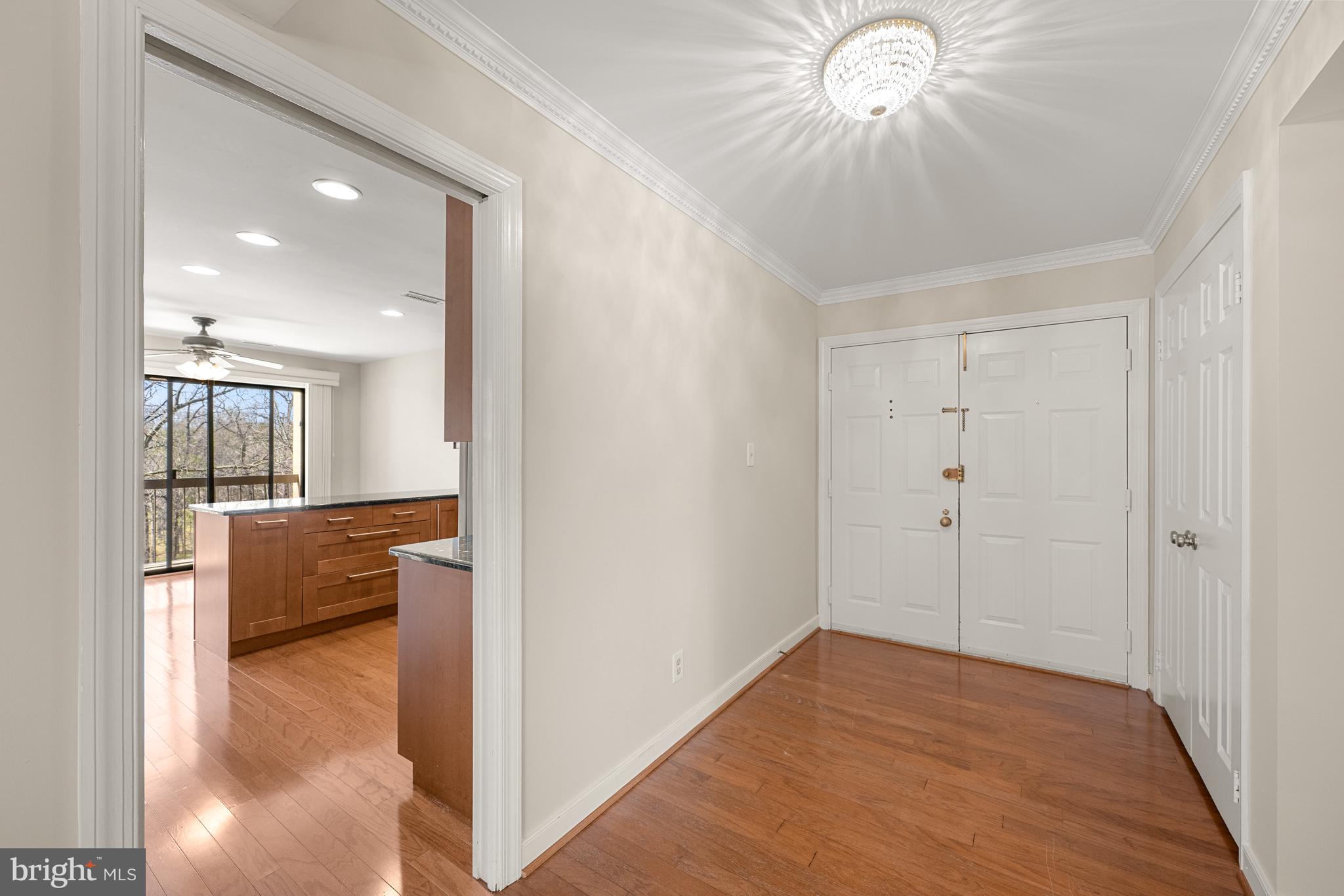 11400 Strand Drive, Unit R310 Rockville, MD 20852 - Photo 3 of 35 a view of kitchen and dining area with chandelier fan