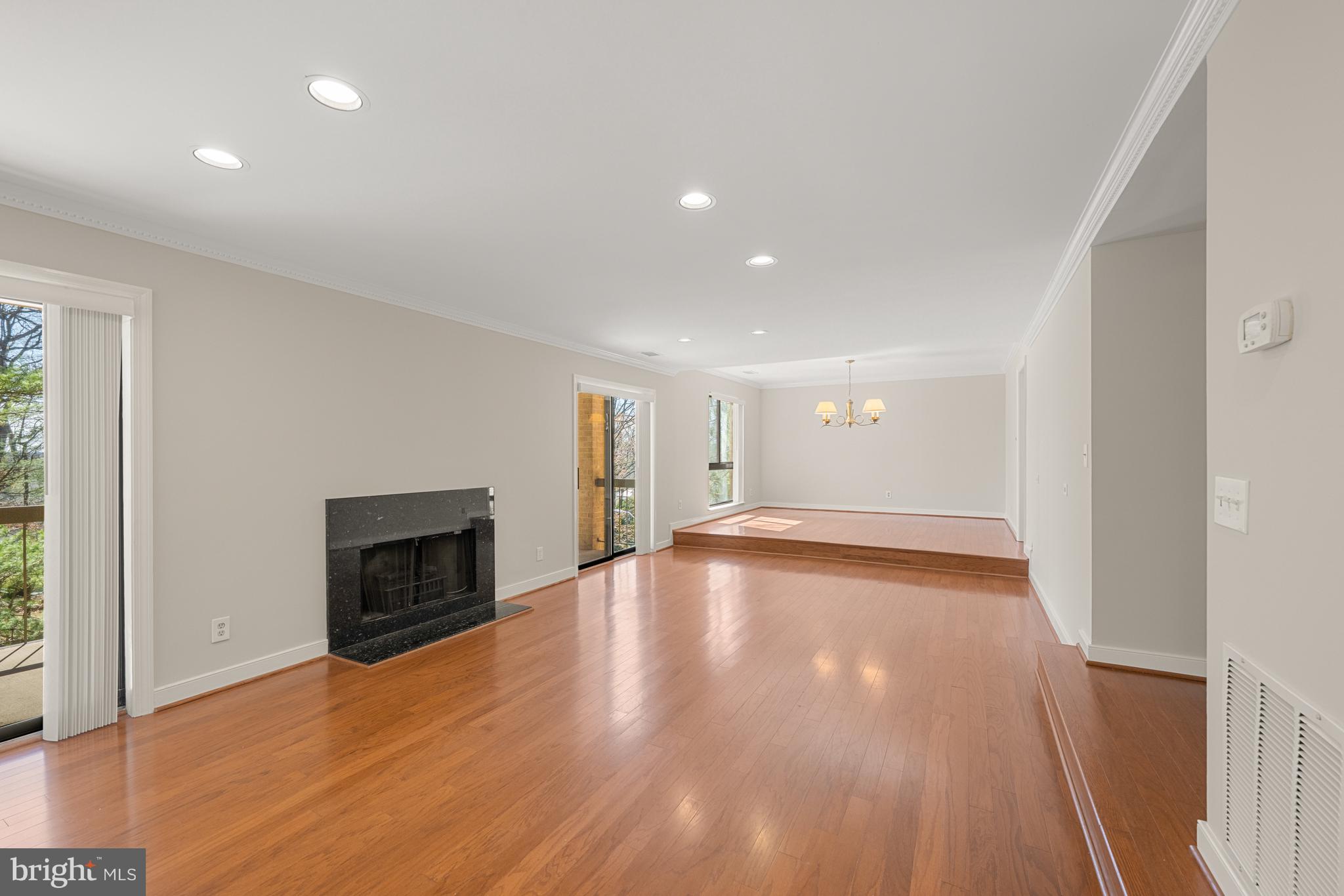 11400 Strand Drive, Unit R310 Rockville, MD 20852 - Photo 5 of 35 a view of empty room with wooden floor and fireplace