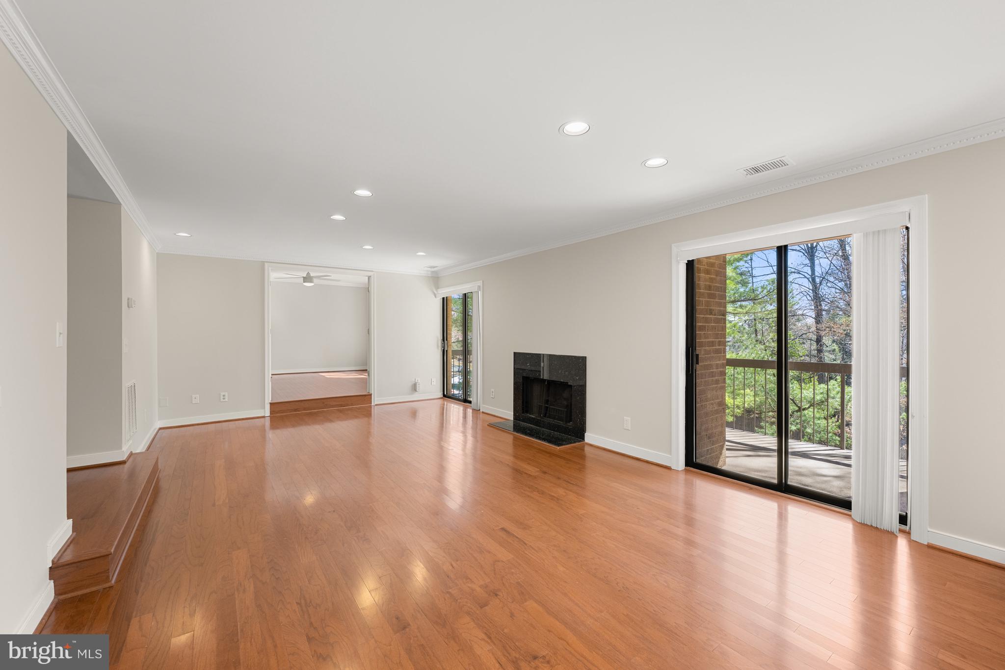 11400 Strand Drive, Unit R310 Rockville, MD 20852 - Photo 7 of 35 a view of an empty room with wooden floor and a window